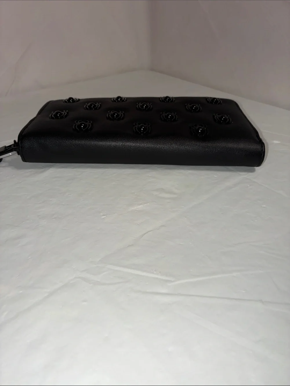 Betsey Johnson Black Wristlet Clutch with Embossed Skull Motif